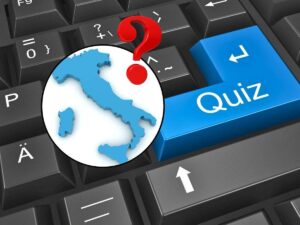 sfondo tastiera pc con scritta Quiz e tondo con Italia e punto interrogativo
